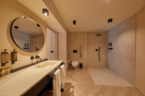 a bathroom with a large mirror and a shower at Belle Marivent Mediterranean Petit Hotel in Palma de Mallorca