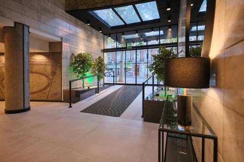 a lobby with potted plants in a building at 1881 Madrid Ventas Hotel in Madrid