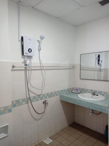 a bathroom with a shower and a sink at Adira Corus Paradise Seaview Family Suite in Port Dickson