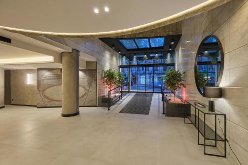 a lobby of a building with a large window at 1881 Madrid Ventas Hotel in Madrid