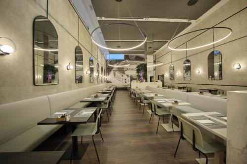 a row of tables and chairs in a restaurant at 1881 Madrid Ventas Hotel in Madrid