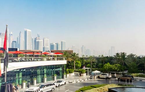 a view of a city with cars parked in a parking lot at Popular Seven Palm Apartments in Dubai