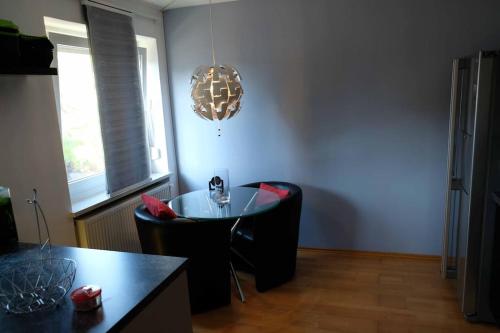 a dining room with a table and a chandelier at Luxurious apartment including wellness in Poing