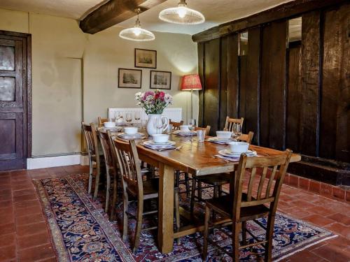 a dining room with a large wooden table and chairs at Elizabethan Manor at gateway to the Brecon Beacons in Abergavenny