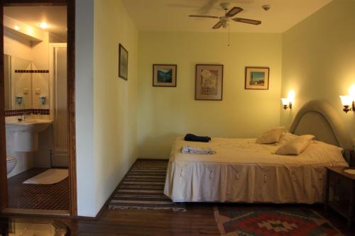 a bedroom with a bed and a mirror at Villa Konak Hotel in Kusadası