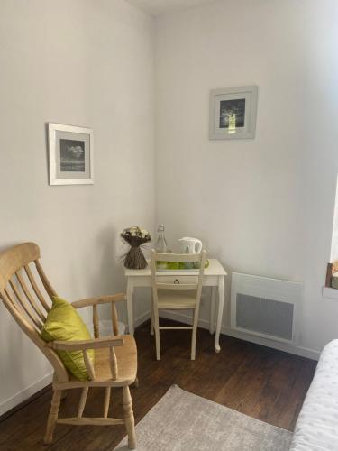 a bedroom with a desk and a chair and a table at Ancien Relais de Poste The Old Post Office in Saint-Martial-dʼAlbarède
