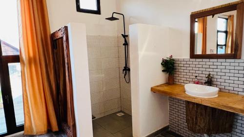 a bathroom with a sink and a mirror at Z-Breeze Zanzibar in Kiwengwa