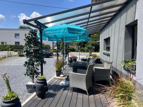 a patio with a table and an umbrella at Dependance Villa Komposch adults only in Reifnitz