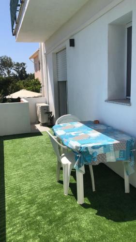 a table and chairs sitting on the grass in a yard at Luscofusco in La Caletta