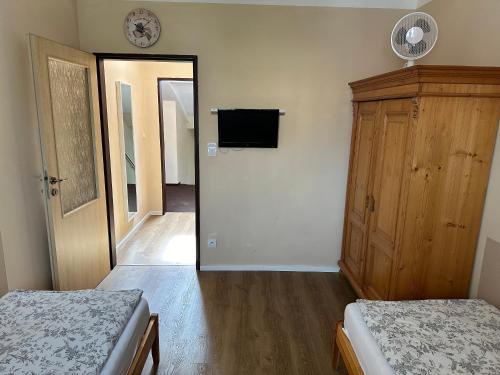 a bedroom with two beds and a tv and a mirror at Penzion Aladdin in Teplice