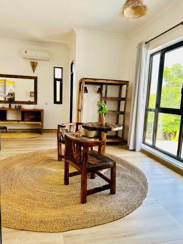 a living room with a bench and a table and a rug at Z-Breeze Zanzibar in Kiwengwa