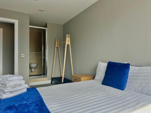 a bedroom with a bed with blue towels on it at Monarchs Quay Arena Apartments by Happy Days in Liverpool