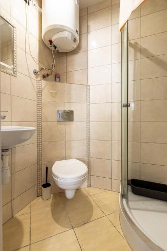 a bathroom with a toilet and a sink at Apartament Na Deptaku 23 in Lublin