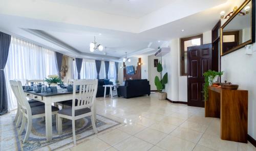 a dining room and living room with a table and chairs at ZaNaKri Homes ;A Great Panorama of Indian Ocean in Mombasa