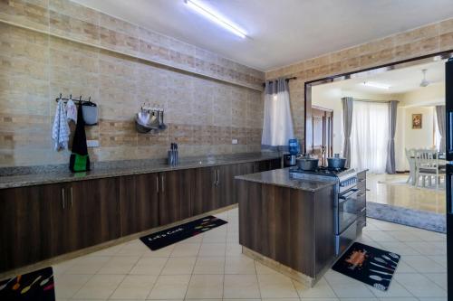 a kitchen with a counter and a stove in it at ZaNaKri Homes ;A Great Panorama of Indian Ocean in Mombasa