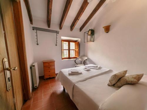 a bedroom with a bed in a room with a window at Petit Hotel Hostatgeria La Victoria in Alcudia