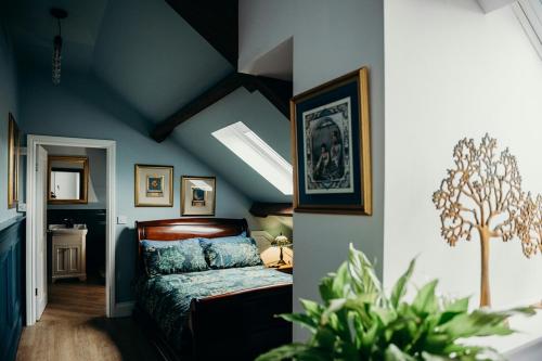 a bedroom with blue walls and a bed in a room at Old Sunday School, Garrigill in Garrigill