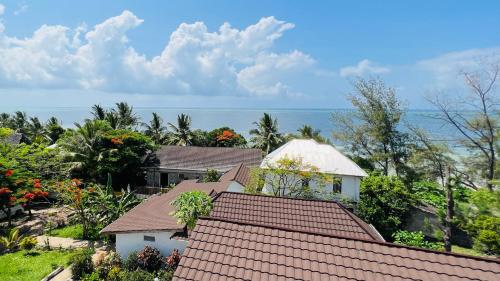 an aerial view of roofs with the ocean in the background at Z-Breeze Zanzibar in Kiwengwa