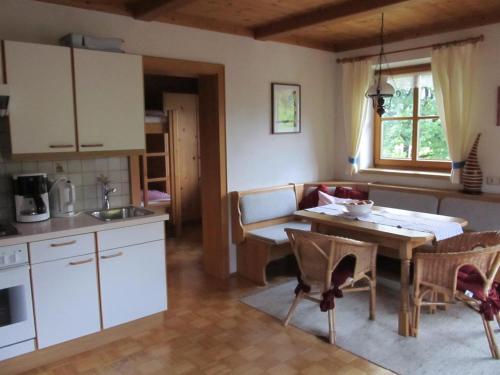 a kitchen and living room with a table and chairs at Lärchenhof in Maria Alm am Steinernen Meer
