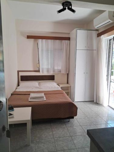 a bedroom with a bed and a ceiling fan at Casa Angelina in Polychrono