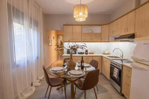 a kitchen with a table and chairs and a sink at Relax house by the sea in Volos