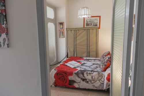 a bedroom with a bed with a red blanket at Il Ritrovo degli Artisti in Castrovillari
