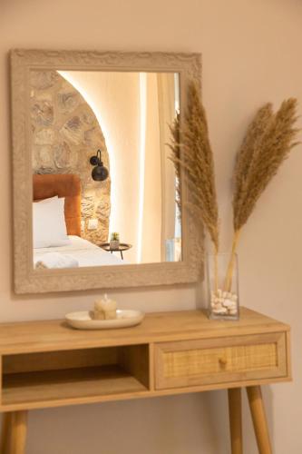 a mirror on top of a wooden table in a bedroom at Relax house by the sea in Volos