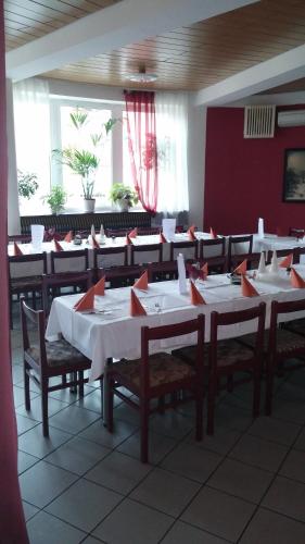 a dining room with white tables and chairs at Hotel Rozvoj in Klatovy