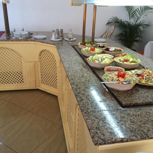a buffet with several plates of food on a counter at Miramar Sharm El Kantaoui ex Miramar Golf in Port El Kantaoui