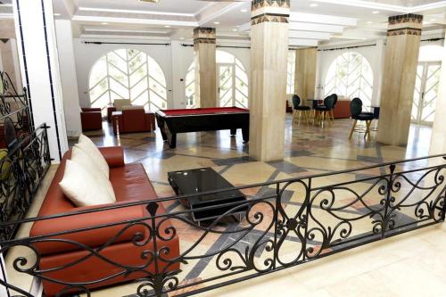 a living room with a couch and a piano at Miramar Sharm El Kantaoui ex Miramar Golf in Port El Kantaoui