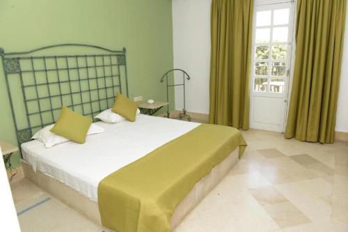 a bedroom with a large bed and a window at Miramar Sharm El Kantaoui ex Miramar Golf in Port El Kantaoui