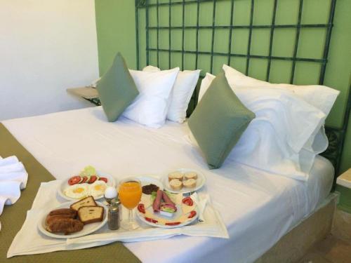 a tray of food on top of a bed at Miramar Sharm El Kantaoui ex Miramar Golf in Port El Kantaoui