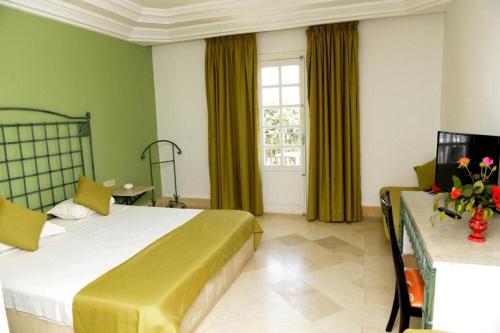 a hotel room with a bed and a window at Miramar Sharm El Kantaoui ex Miramar Golf in Port El Kantaoui