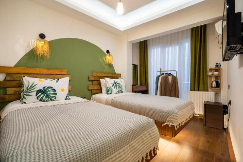 a hotel room with two beds and a television at York House İstanbul in Istanbul