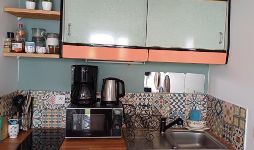 a kitchen with a sink and a microwave at COUP DE COEUR Studio in Rivedoux-Plage