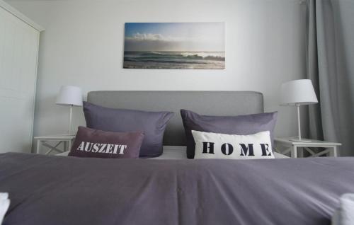 a bedroom with a bed with two pillows on it at Blaue Ferne in Olpenitz