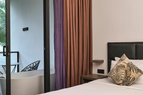 Un dormitorio con una cama con una almohada encima. en White Apart Cambodia, en Sihanoukville