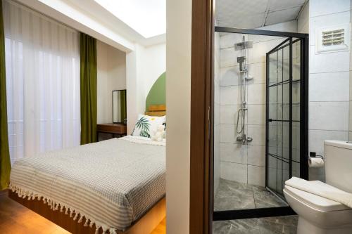a bathroom with a bed and a shower at York House İstanbul in Istanbul
