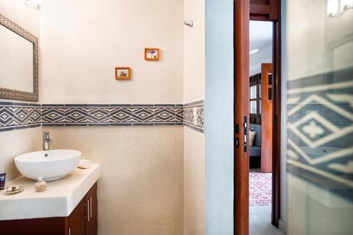 a bathroom with a sink and a mirror at Boutique by The Museo in Mérida