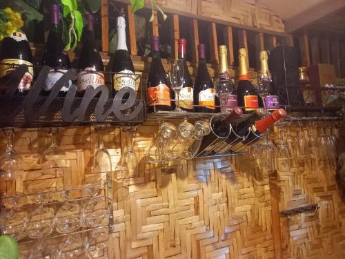 a bar with many bottles of wine and glasses at Hidden Tourist Inn in Mambajao