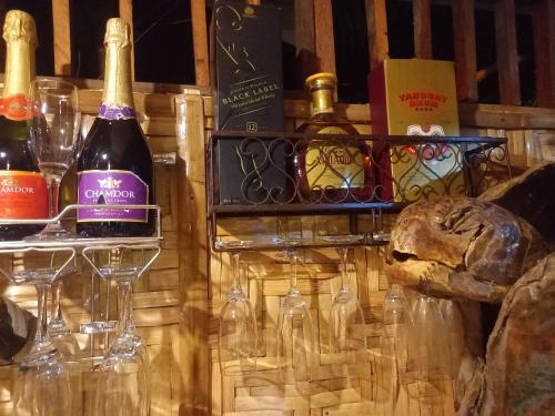 two bottles of wine and glasses on a table at Hidden Tourist Inn in Mambajao