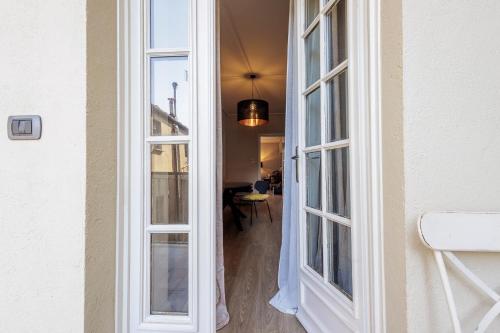 a hallway with two large windows in a house at Virgula Maison 2 in Cuneo