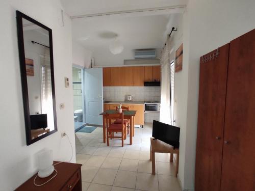a kitchen and dining room with a table and chairs at Chalkidonos in Heraklio Town