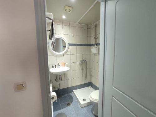 a small bathroom with a sink and a toilet at Chalkidonos in Heraklio Town