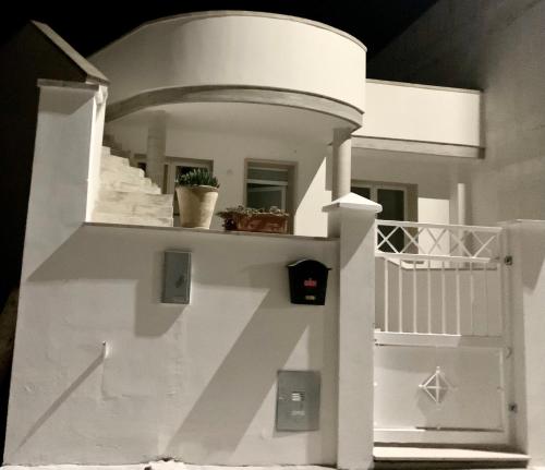 a white house with a white stair case at B&B Passione Salento in Surbo