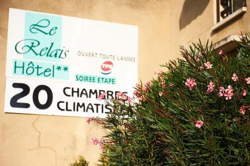 a sign that is on the side of a building at Hôtel Le Relais in Fleurance