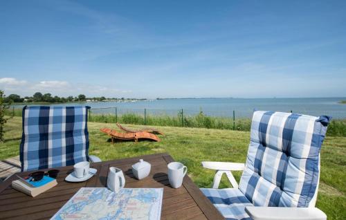 a table and two chairs with a view of the water at Sternschnuppe in Olpenitz