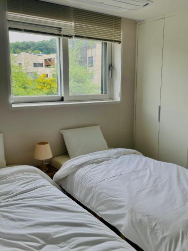 a bedroom with a bed and a window at Asla stay in Incheon