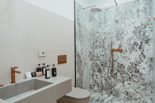 a bathroom with a shower with a toilet and a sink at Luxury apartment-Quartieri Spagn by Alux38 in Naples