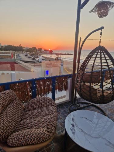 a patio with a swing and a chair and a table at Gloo Glamping "by Checkin" in Analipsi